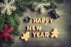 Happy New Year cookies on wooden background with blank space